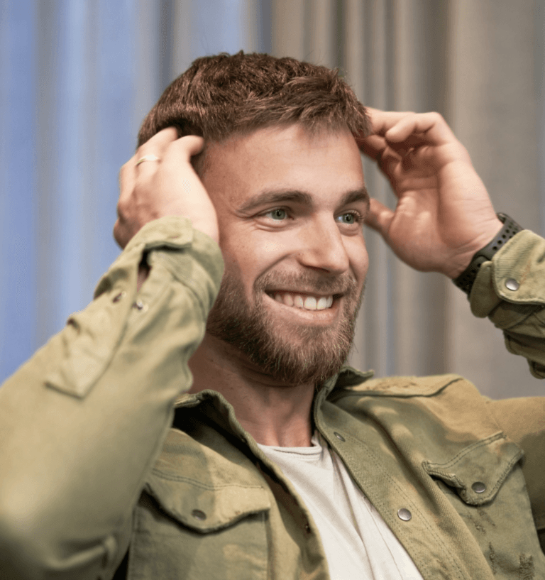 Smiling man after successful non-surgical hair replacement service