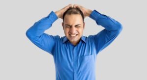A man revealing significant thinning of hair on the crown of his scalp.