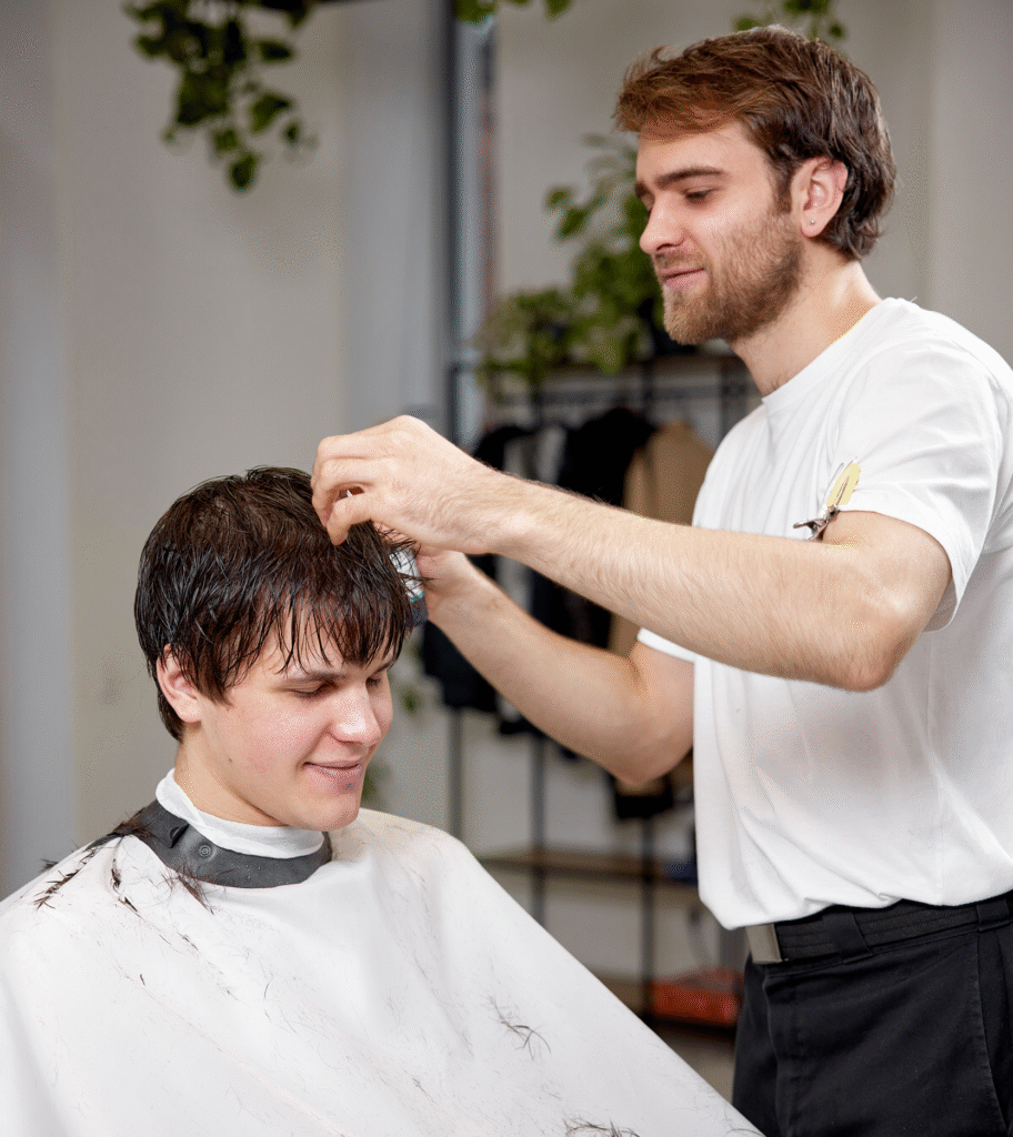 Certified Hair System Stylist training instructor cutting hair system for a man